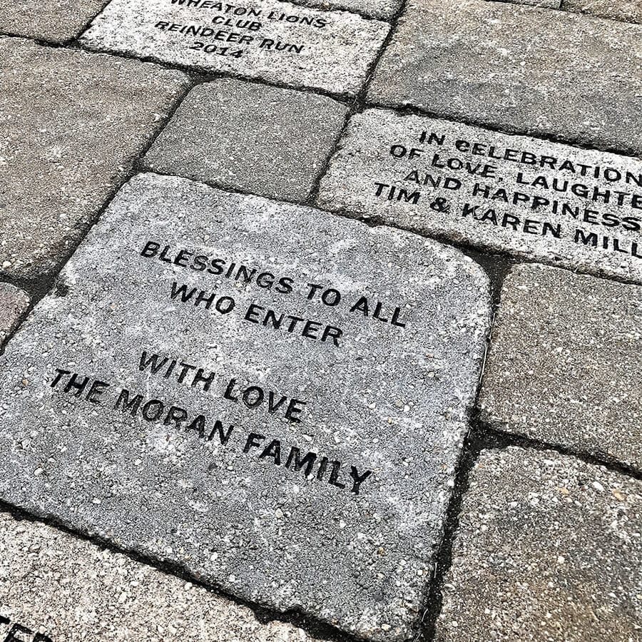 Patio brick with inscription that says "Blessings to all who enter. With love, the Moran Family"