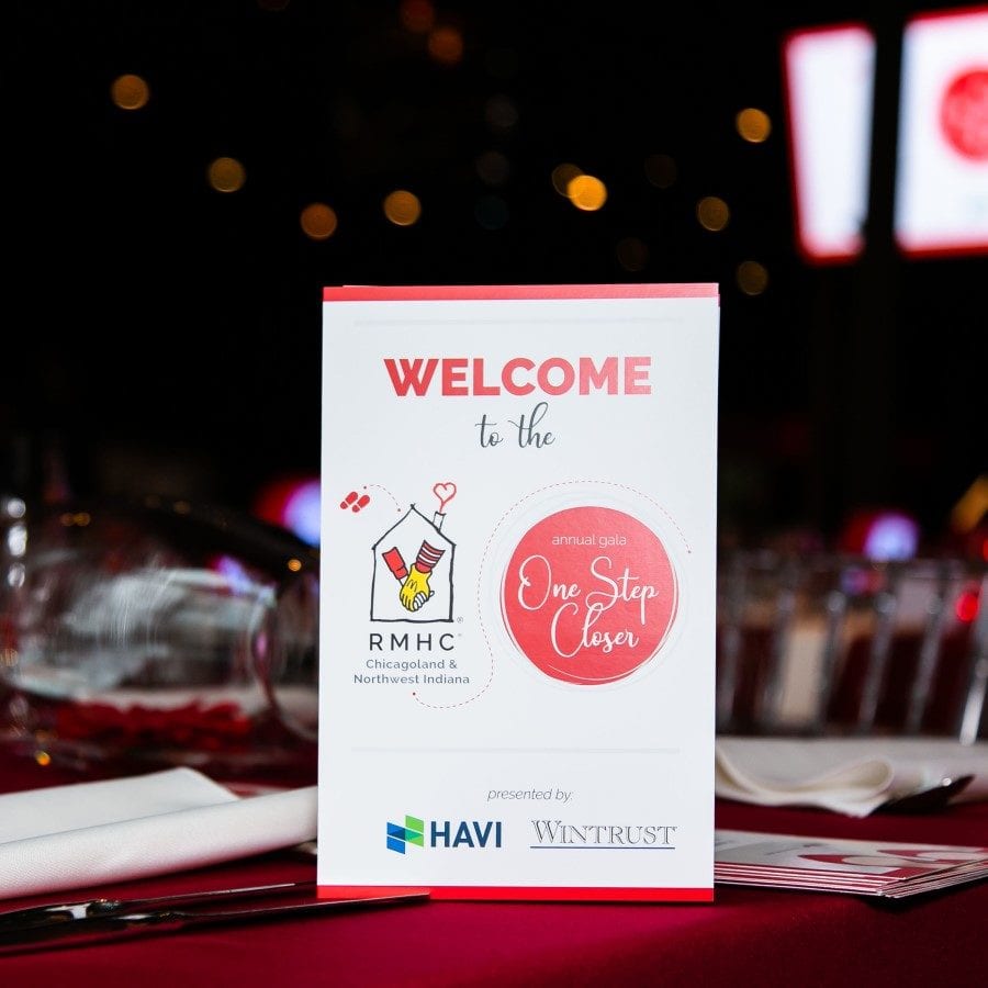 Sign welcoming attendees to gala with sponsor logos