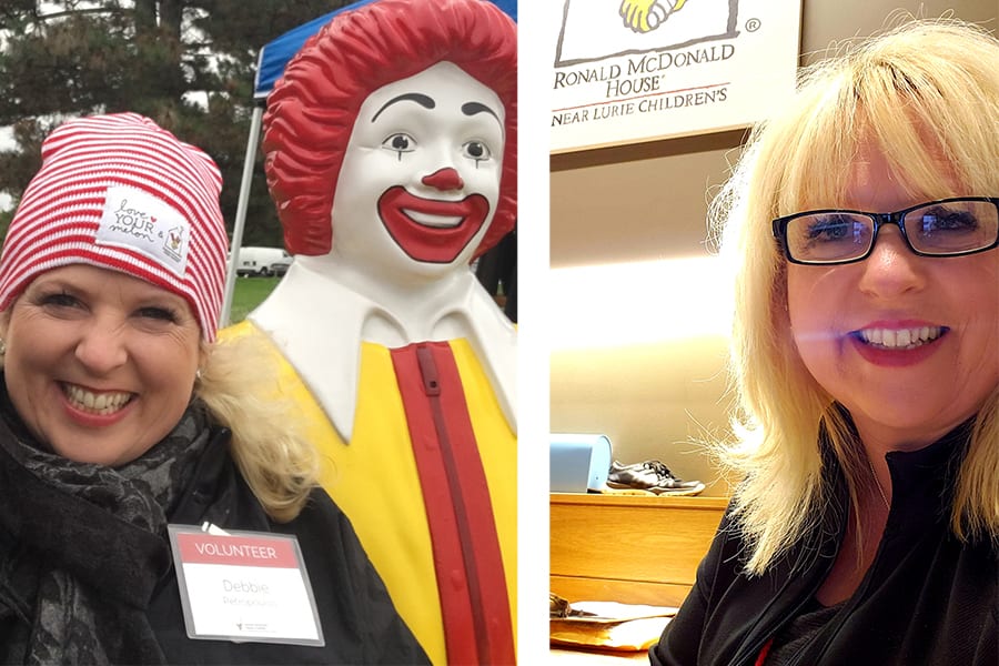A blond woman stands and smiles next to a statue of Ronald McDonald.