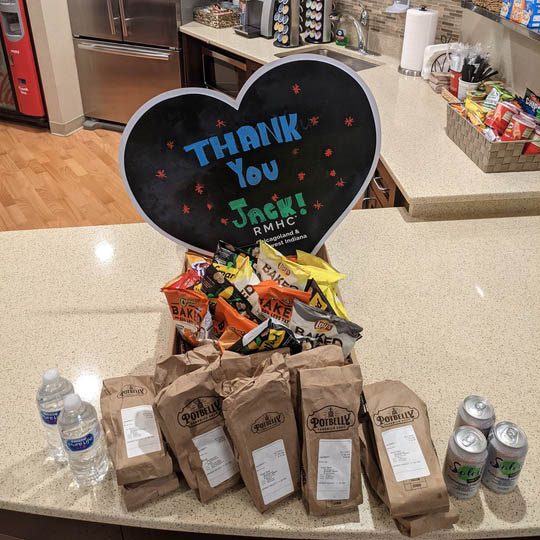 Several boxed meals sit on a counter in front of a chalkboard sign that reads "Thanks you Jack!"