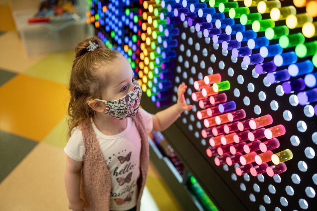 Little girl plays with a giant Lite-Brite