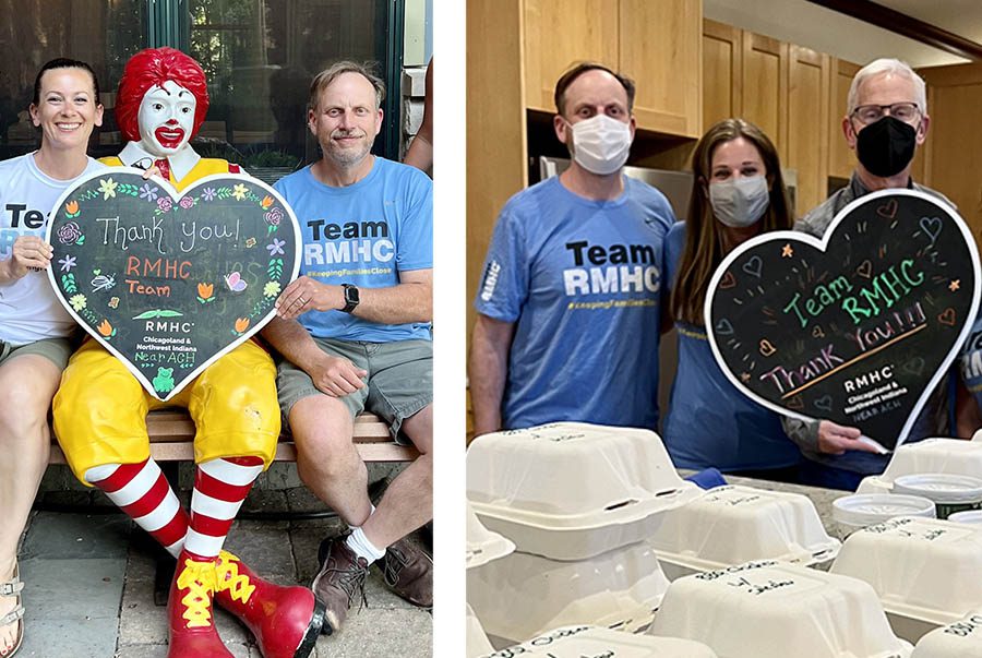A man in a blue short that reads "Team RMHC" stands behind a counter full of boxed meals